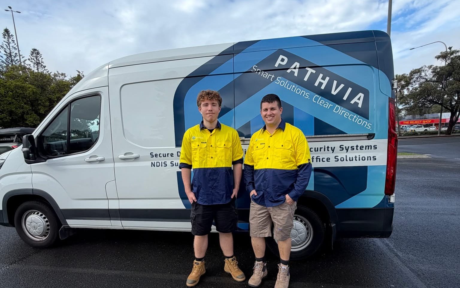 Two Pathvia staff in high visibility shirts in front of the branded Pathvia van